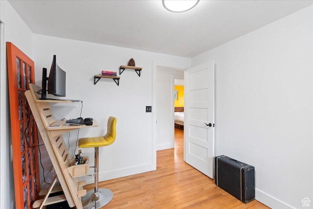bedroom featuring light wood-style flooring and baseboards