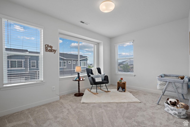 sitting room featuring carpet flooring and baseboards