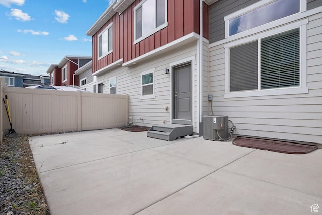 view of patio with cooling unit and fence