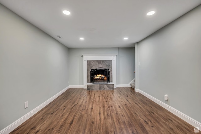 476 E 3050 N, North Ogden, UT 84414 - unfurnished living room featuring a tiled fireplace, baseboards, recessed lighting, dark wood-type flooring, and stairway