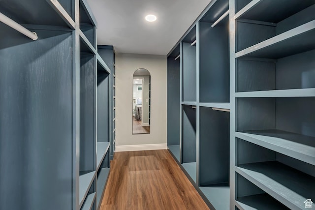 476 E 3050 N, North Ogden, UT 84414 - walk in closet featuring arched walkways and dark wood-type flooring