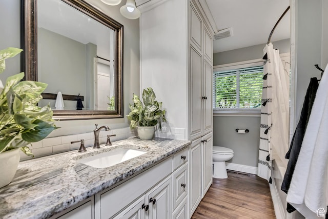 476 E 3050 N, North Ogden, UT 84414 - full bathroom with toilet, vanity, wood finished floors, baseboards, and shower / bath combo with shower curtain