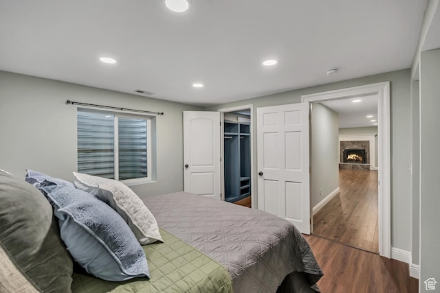476 E 3050 N, North Ogden, UT 84414 - bedroom featuring wood finished floors, a premium fireplace, baseboards, recessed lighting, and a walk in closet
