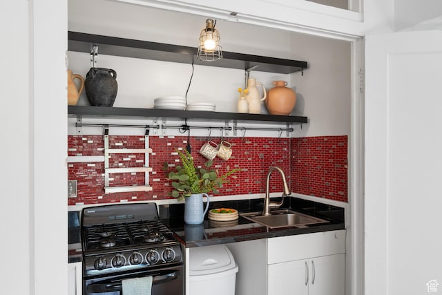 86 N B St Unit 34, Salt Lake City, UT 84150 - kitchen with black gas range, a sink, open shelves, dark countertops, and white cabinets