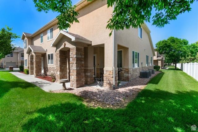 view of side of home featuring stone siding and stucco siding