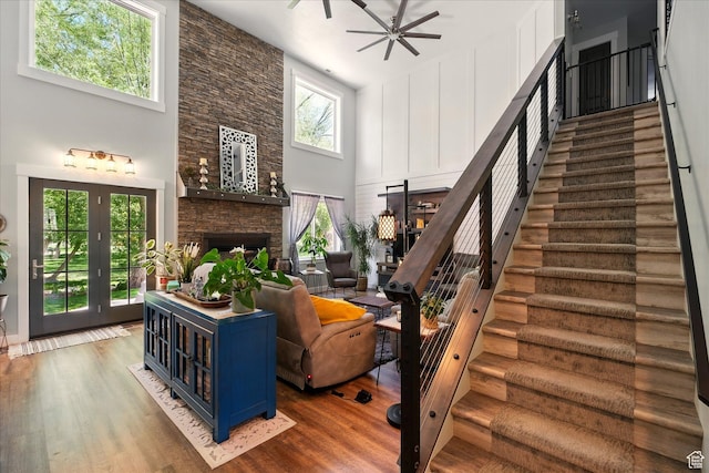 538 W 600 S, Logan, UT 84321 - staircase with a high ceiling, a stone fireplace, wood finished floors, and ceiling fan