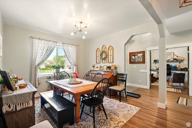 538 W 600 S, Logan, UT 84321 - dining space featuring arched walkways, light wood-style flooring, a chandelier, baseboards, and an office area