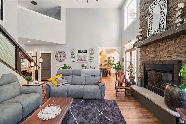 538 W 600 S, Logan, UT 84321 - living room featuring wood finished floors, a high ceiling, a fireplace, and stairway