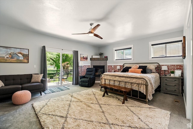 538 W 600 S, Logan, UT 84321 - carpeted bedroom with access to outside, multiple windows, a glass covered fireplace, and a ceiling fan