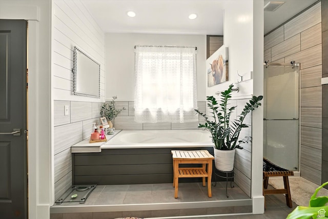 538 W 600 S, Logan, UT 84321 - bathroom with tile walls, a bath, a stall shower, tile patterned floors, and recessed lighting
