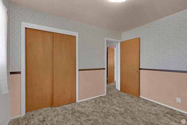 3927 W Rawhide Dr S, West Valley City, UT 84120 - unfurnished bedroom with wallpapered walls, a closet, and carpet floors