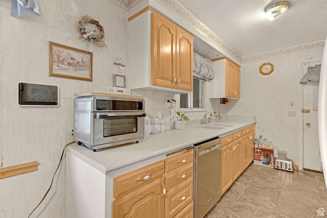 3927 W Rawhide Dr S, West Valley City, UT 84120 - kitchen with dishwasher, a sink, light countertops, and wallpapered walls