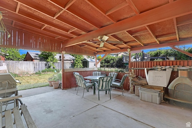 3927 W Rawhide Dr S, West Valley City, UT 84120 - view of patio featuring a shed, outdoor dining space, a fenced backyard, and an outbuilding