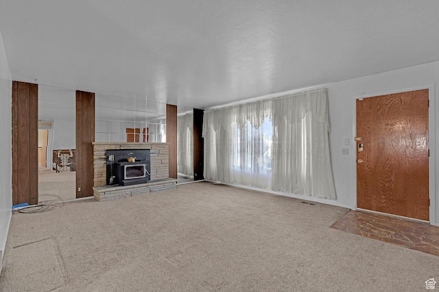 3927 W Rawhide Dr S, West Valley City, UT 84120 - unfurnished living room with carpet flooring and a wood stove