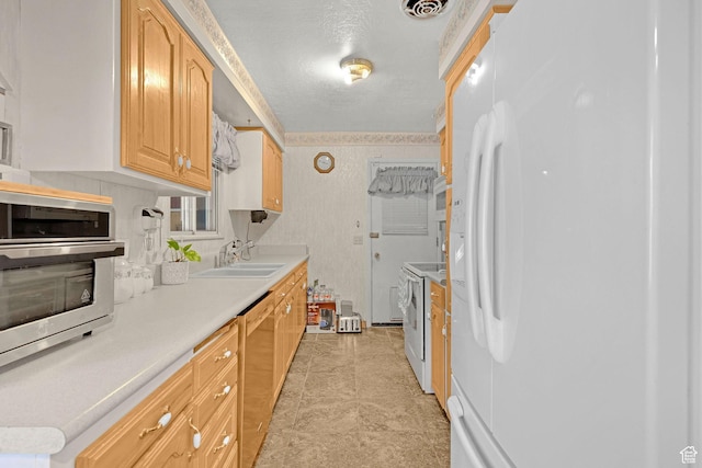 3927 W Rawhide Dr S, West Valley City, UT 84120 - kitchen featuring white appliances, a sink, light countertops, and light brown cabinetry