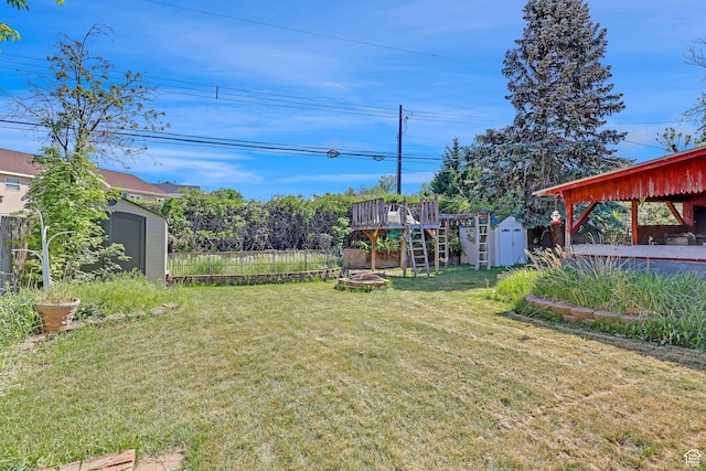 3927 W Rawhide Dr S, West Valley City, UT 84120 - view of yard with a storage shed, an outdoor structure, and a fire pit