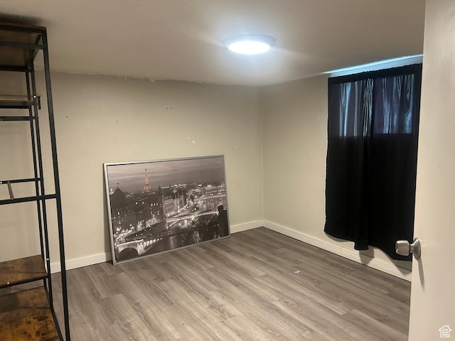 empty room with wood finished floors and baseboards