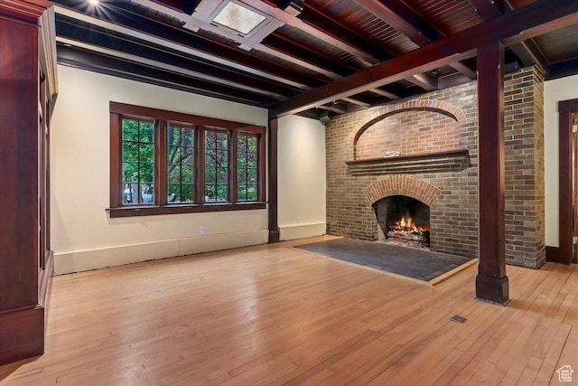 34 S Haxton Pl, Salt Lake City, UT 84102 - unfurnished living room with beamed ceiling, hardwood / wood-style floors, baseboards, and a fireplace