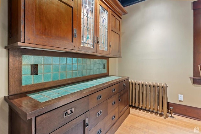 34 S Haxton Pl, Salt Lake City, UT 84102 - detailed view of radiator, decorative backsplash, and wood finished floors