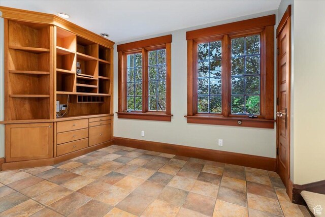 34 S Haxton Pl, Salt Lake City, UT 84102 - unfurnished room featuring baseboards and light stone finish flooring
