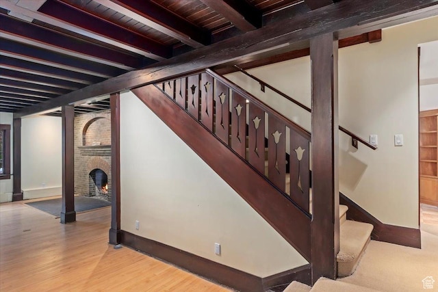 34 S Haxton Pl, Salt Lake City, UT 84102 - stairs featuring baseboards, wood finished floors, beamed ceiling, wood ceiling, and a fireplace