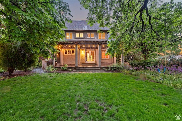 34 S Haxton Pl, Salt Lake City, UT 84102 - back of property at dusk featuring a lawn and covered porch