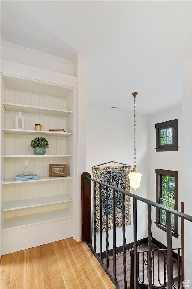 35 S Haxton Pl, Salt Lake City, UT 84102 - hallway with an upstairs landing, built in shelves, and wood finished floors