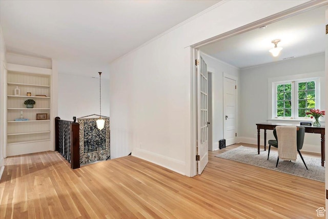 35 S Haxton Pl, Salt Lake City, UT 84102 - corridor with light wood-style flooring, crown molding, built in shelves, a desk, and baseboards