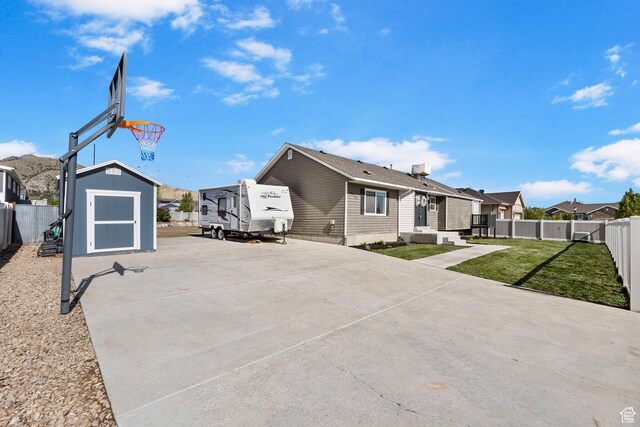 13956 S Wild Colt Cir, Herriman, UT 84096 - rear view of house featuring a shed, a residential view, an outdoor structure, and a patio