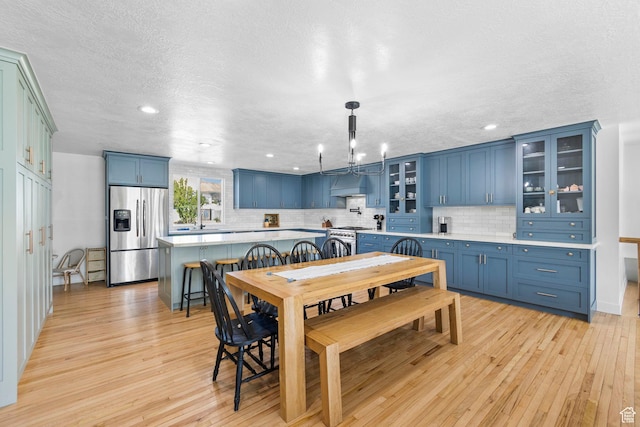 13956 S Wild Colt Cir, Herriman, UT 84096 - dining area with light wood-style flooring, a chandelier, recessed lighting, and a textured ceiling