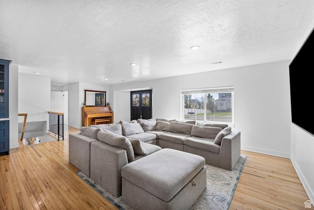 13956 S Wild Colt Cir, Herriman, UT 84096 - living room with a textured ceiling, light wood finished floors, baseboards, and recessed lighting