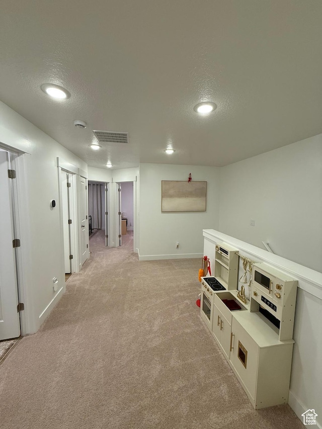 81 W 925 N, Brigham City, UT 84302 - corridor featuring light carpet, a textured ceiling, baseboards, recessed lighting, and washer / dryer