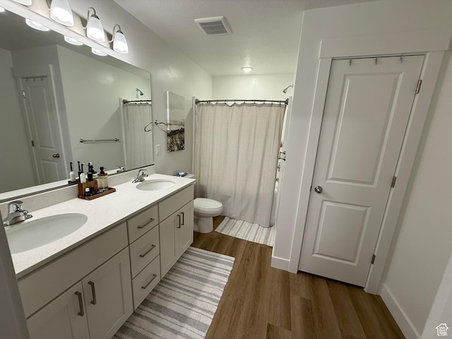 81 W 925 N, Brigham City, UT 84302 - full bath featuring wood finished floors, toilet, curtained shower, double vanity, and baseboards