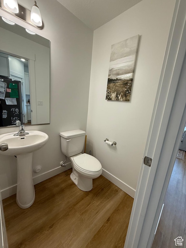 81 W 925 N, Brigham City, UT 84302 - half bathroom featuring wood finished floors, toilet, and baseboards