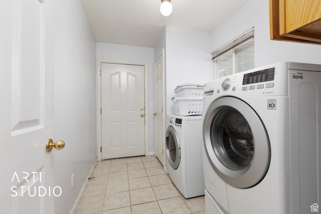 2956 W Mackay Meadows Pl, West Valley City, UT 84119 - laundry room featuring washing machine and dryer, light tile patterned floors, baseboards, and cabinet space