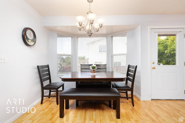 2956 W Mackay Meadows Pl, West Valley City, UT 84119 - dining room with a chandelier, light wood-style floors, and baseboards