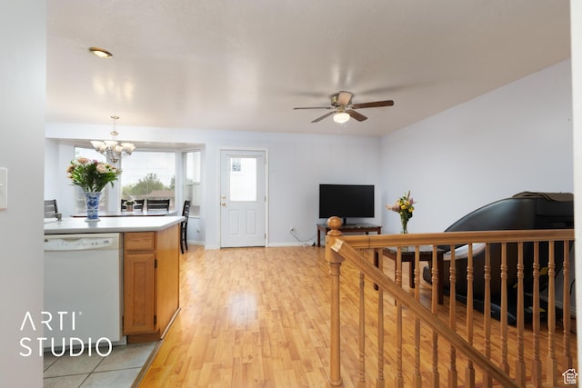 2956 W Mackay Meadows Pl, West Valley City, UT 84119 - kitchen featuring white dishwasher, a ceiling fan, a chandelier, light countertops, and light wood-style floors