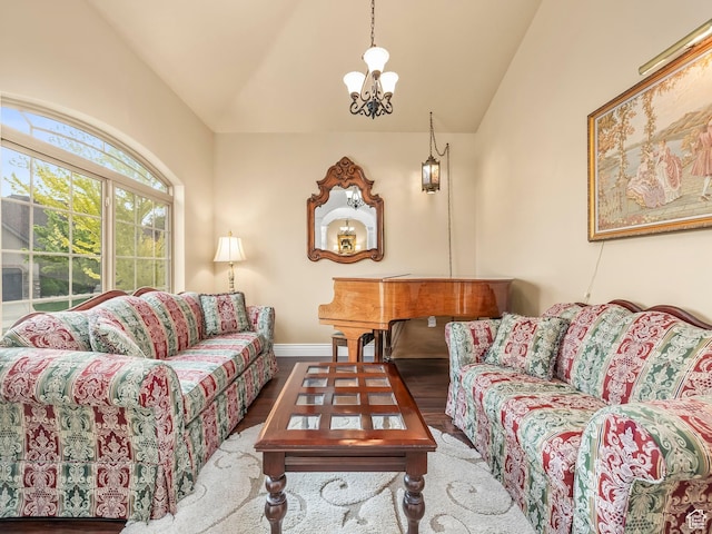 living room with lofted ceiling, wood finished floors, and baseboards