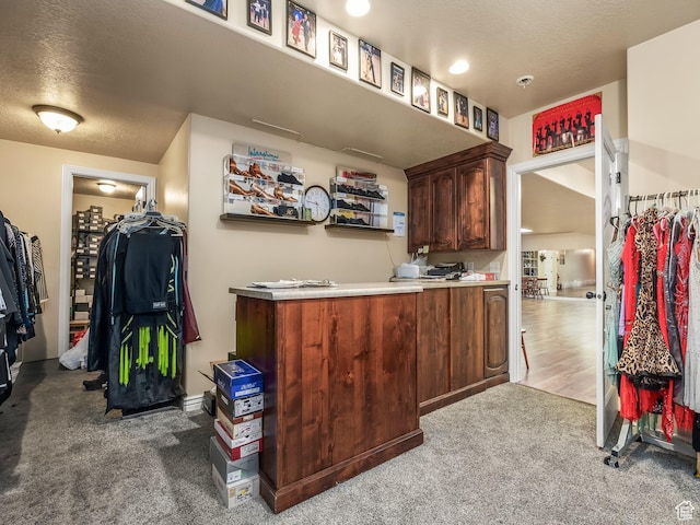 bar featuring carpet floors and a textured ceiling