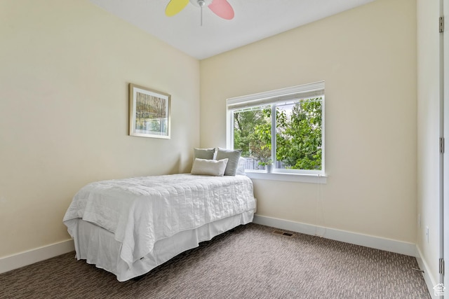 carpeted bedroom with baseboards and a ceiling fan