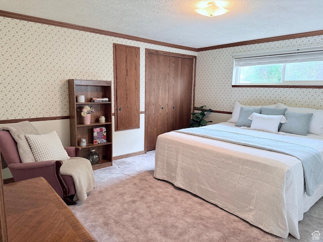 bedroom featuring wallpapered walls, crown molding, a closet, light colored carpet, and a textured ceiling