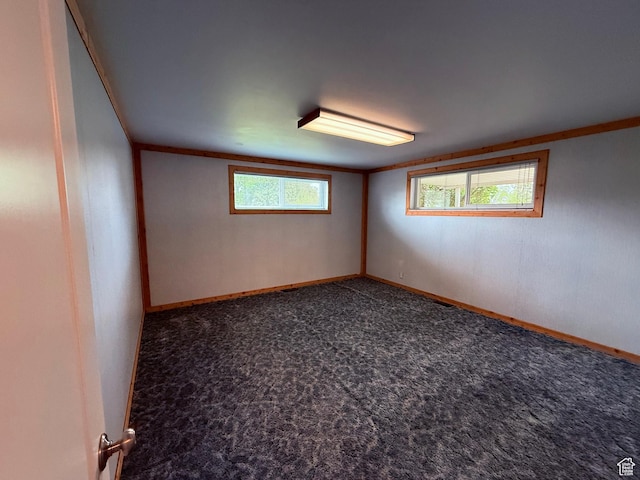 empty room featuring carpet floors and baseboards