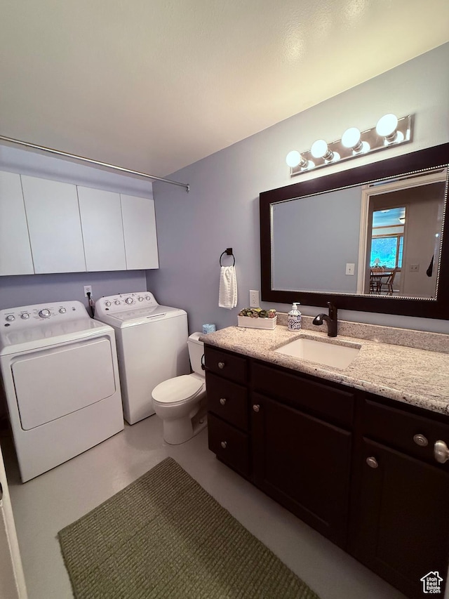 bathroom with separate washer and dryer, toilet, and vanity