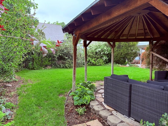 view of grassy yard featuring a gazebo, an outdoor hangout area, and a patio