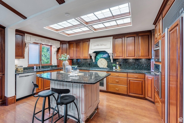 3223 Apache Ln, Provo, UT 84604 - kitchen with stainless steel appliances, a kitchen breakfast bar, light wood-style flooring, and a sink