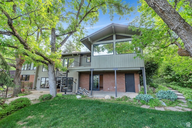 3223 Apache Ln, Provo, UT 84604 - back of house with stairs, brick siding, a yard, and a patio area