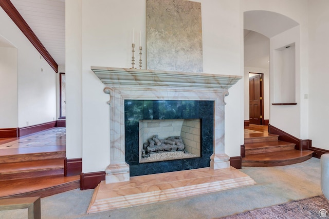 3223 Apache Ln, Provo, UT 84604 - detailed view of carpet, a tile fireplace, arched walkways, and baseboards