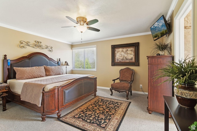 bedroom featuring light colored carpet, ornamental molding, baseboards, and a ceiling fan