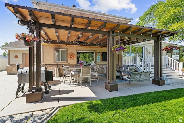 view of patio with ceiling fan, grilling area, and outdoor dining area