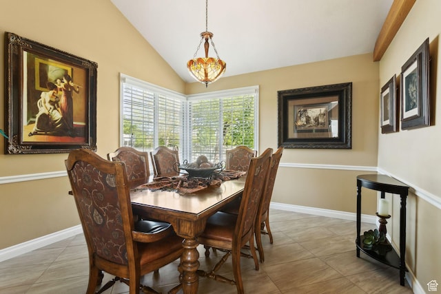 dining space featuring tile patterned floors, vaulted ceiling, and baseboards